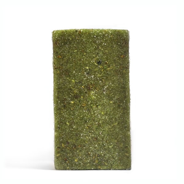 Dried magic mushroom brick with green moldy surface for psychedelic effects.